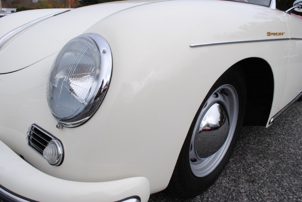 Refined collector-grade 1957 Porsche 356A Speedster with sharp white finish and expertly stitched red leather cabin seats..