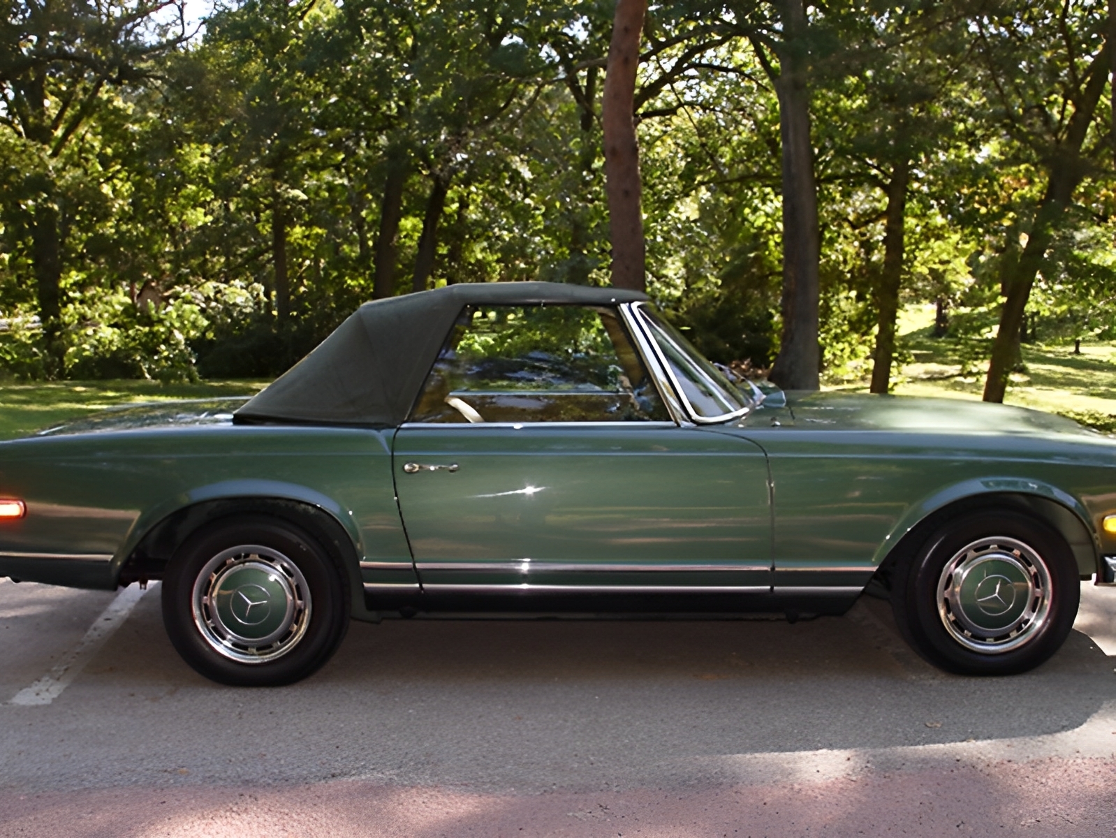 Timeless collector car: 1970 Mercedes 280SL Pagoda, automatic transmission, classic green paint, and showroom-level tan interior finish.