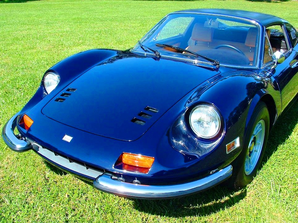 Blue 1974 Ferrari 246 GTS Dino convertible with pristine tan Daytona seats, plated mechanicals, and full dash restoration using mouse fur material.